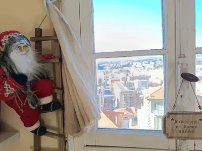 a santa claus sitting on a shelf in a window at Double room with great view in Nice