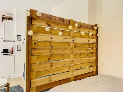 a wooden wall in a room with a bed at Appartement Terrasse Proche Port et Plages de Nice in Nice