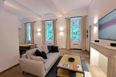 a living room with a couch and a large screen tv at 06A4 - Situation exceptionnelle au Port de Nice in Nice