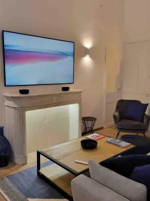 a living room with a large flat screen tv above a fireplace at 06A4 - Situation exceptionnelle au Port de Nice in Nice