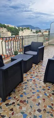 a patio with chairs and tables on a balcony at NICE STUDIO 26m2 avec TERRASSE 16m2 in Nice