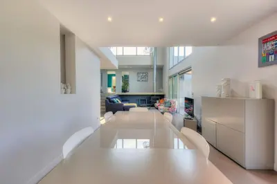 a living room with a table and a couch at Villa Contemporaine à Carros les plans in Carros