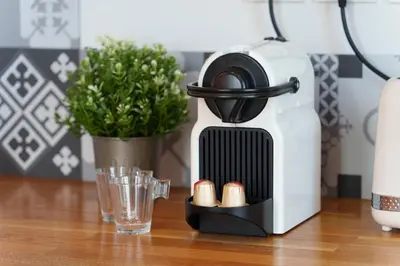 a coffee maker sitting on a table next to a glass at Nice Renting - CAMBRAI03 - Seaside Studio on the Promenade des Anglais in Nice