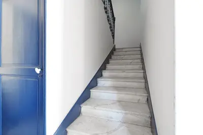 a stairway with a blue door and a blue doorstep at Nice Renting - CAMBRAI03 - Seaside Studio on the Promenade des Anglais in Nice