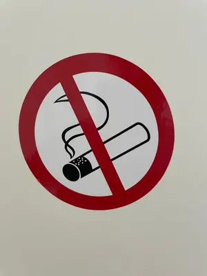 a no smoking sign on a white wall at Nice Renting - CAMBRAI03 - Seaside Studio on the Promenade des Anglais in Nice