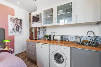 a kitchen with a washing machine and a sink at Nice Renting - CAMBRAI03 - Seaside Studio on the Promenade des Anglais in Nice