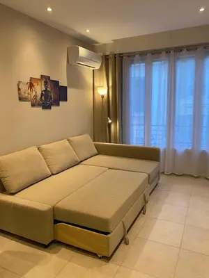 a large bed in a room with a large window at The entire apartment 2 rooms, Balcony, Sea view in Nice