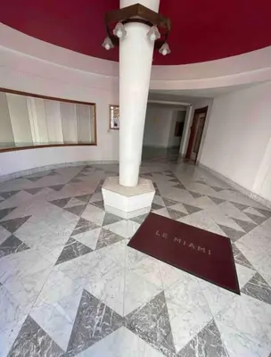 a room with a column and a sign on the floor at The entire apartment 2 rooms, Balcony, Sea view in Nice