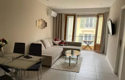 a living room with a couch and a table at The entire apartment 2 rooms, Balcony, Sea view in Nice