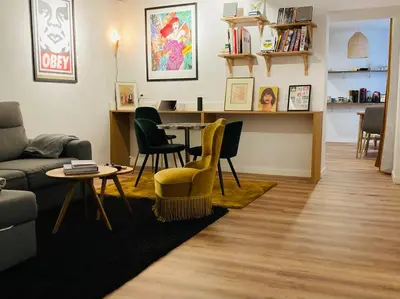 a living room with a couch and a table and chairs at Appartement Vieux Nice Garibaldi rénové in Nice