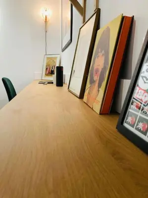 a wooden table with pictures on top of it at Appartement Vieux Nice Garibaldi rénové in Nice