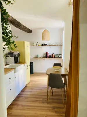 a kitchen with a table and a small table and chairs at Appartement Vieux Nice Garibaldi rénové in Nice