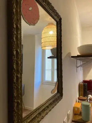 a mirror on the wall of a room with a window at Appartement Vieux Nice Garibaldi rénové in Nice