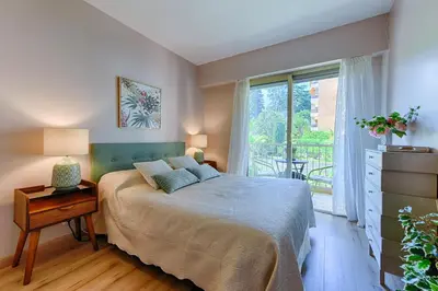 a bedroom with a bed and a large window at Happyfew Sainte Anne in Nice
