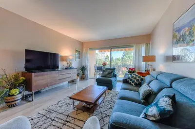 a living room with a blue couch and a flat screen tv at Happyfew Sainte Anne in Nice