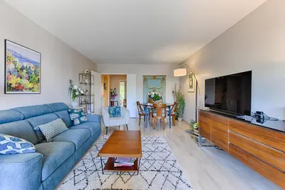 a living room with a blue couch and a flat screen tv at Happyfew Sainte Anne in Nice
