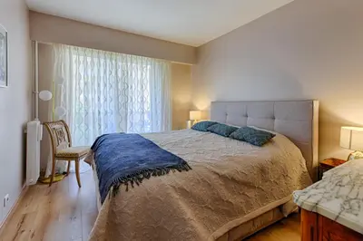 a bedroom with a large bed and a window at Happyfew Sainte Anne in Nice