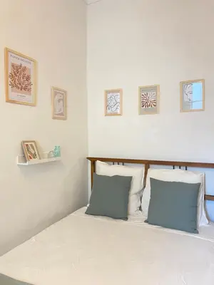 a bedroom with a bed with white sheets and blue pillows at Cosy Blue Nice in Nice