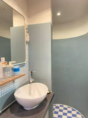 a bathroom with a large white sink and a mirror at Cosy Blue Nice in Nice