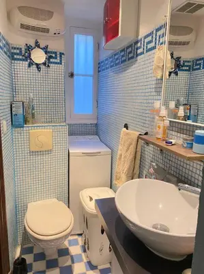 a blue and white bathroom with a toilet and a sink at Cosy Blue Nice in Nice