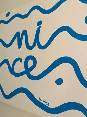 a close up of a sign that reads me is nice at Cosy Blue Nice in Nice