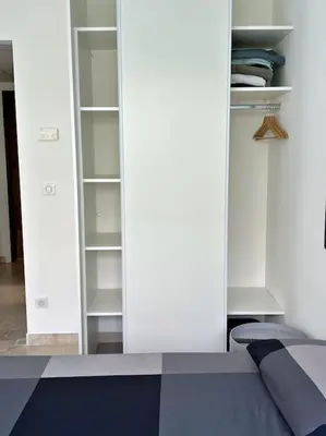 a white closet with a bed in a room at Carré d'or Studio 2 in Nice