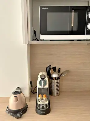 a kitchen counter with a microwave and some appliances at Carré d'or Studio 2 in Nice