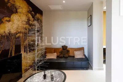 a teddy bear sitting on a couch in a living room at Villa Vue Mer, Piscine & Plage à 6Min in Cagnes-sur-Mer