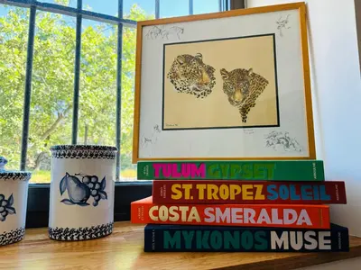 a pile of books sitting on a table next to a window at Paisible et Spacieuse Villa avec 4 suites indépendantes in La Gaude