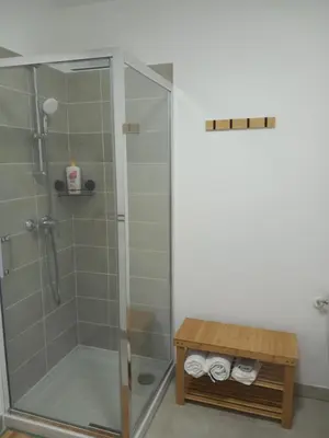 a shower in a bathroom with a glass shower stall at Chez Candie in La Trinité