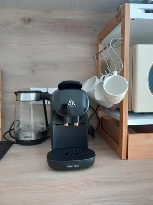 a black coffee maker sitting on a kitchen counter at Chez Candie in La Trinité