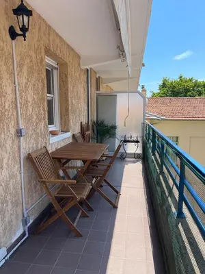 a patio with a table and chairs on a balcony at 2/3 pièces avec terrasse à NICE in Nice