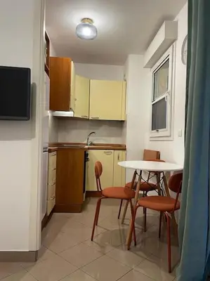 a kitchen with a table and chairs and a table and a table at 2/3 pièces avec terrasse à NICE in Nice