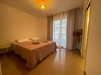a bedroom with a bed and a large window at 2/3 pièces avec terrasse à NICE in Nice
