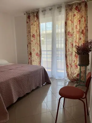 a bedroom with a bed and a chair and a window at 2/3 pièces avec terrasse à NICE in Nice