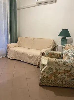 a living room with a couch and a chair at 2/3 pièces avec terrasse à NICE in Nice