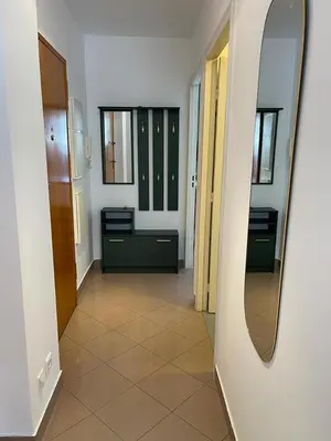 a room with a mirror and a hallway with cabinets at 2/3 pièces avec terrasse à NICE in Nice