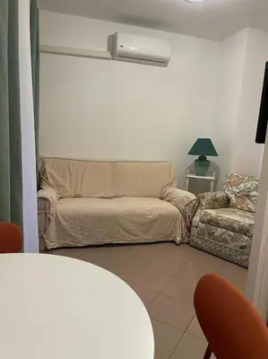 a living room with a couch and a chair at 2/3 pièces avec terrasse à NICE in Nice