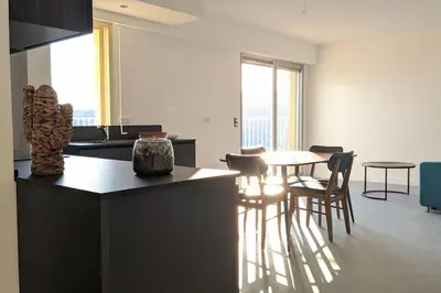 a kitchen and dining room with a table and chairs at 3 pièces dans villa avec piscine in Nice