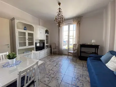 a living room with a blue couch and a table at BEAUTIFUL renovated apartment ,NEXT TO THE BEACH ! AIR-C, FREE PARKING! in Nice