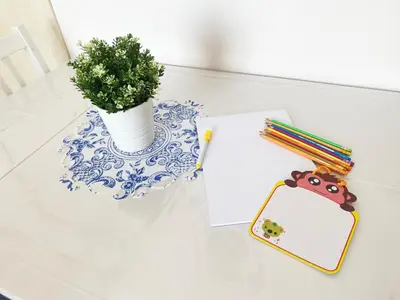 a table with a vase with a plant and a clipboard at BEAUTIFUL renovated apartment ,NEXT TO THE BEACH ! AIR-C, FREE PARKING! in Nice
