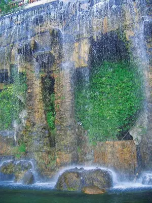 a waterfall on the side of a stone wall at BEAUTIFUL renovated apartment ,NEXT TO THE BEACH ! AIR-C, FREE PARKING! in Nice