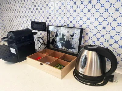 a tea kettle sitting next to a box on a counter at BEAUTIFUL renovated apartment ,NEXT TO THE BEACH ! AIR-C, FREE PARKING! in Nice