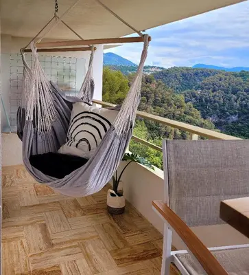 a hammock hanging from a balcony with a view at Studio climatisé vue imprenable wifi in Vence