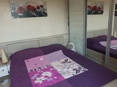 a bedroom with a purple bed and a mirror at VILLA DE CHARME sur la Côte d'Azur in Tourrette-Levens