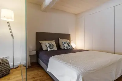 a bedroom with a bed and a glass wall at Joli loft entre le vieux Nice et le port in Nice
