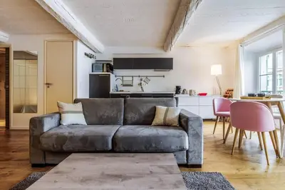 a living room with a couch and a kitchen at Joli loft entre le vieux Nice et le port in Nice