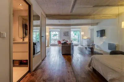 a living room with a bed and a living room with a table at Joli loft entre le vieux Nice et le port in Nice