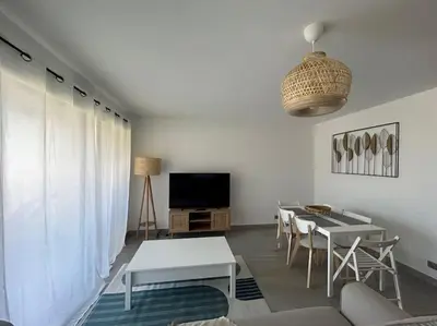 a living room with a couch and a table and a tv at Prestige View 103 By Avecoeur in Èze