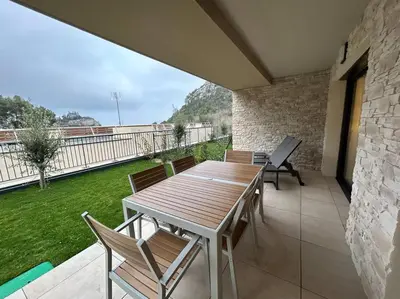 a wooden table and chairs on a patio at Prestige View 103 By Avecoeur in Èze
